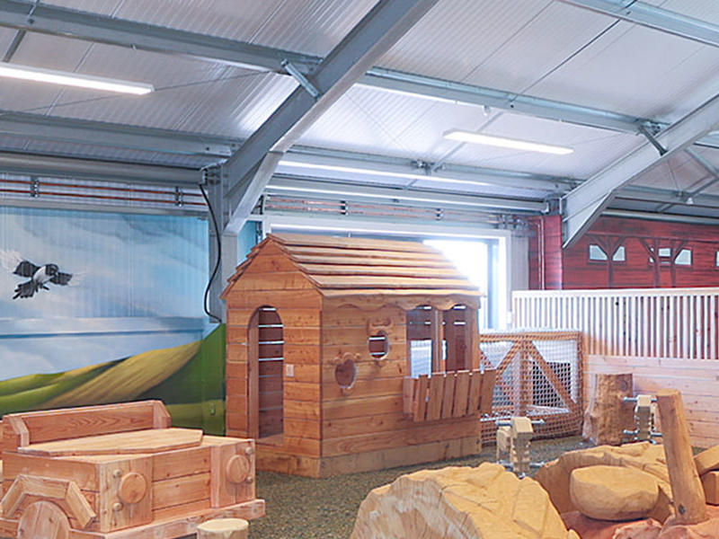 Wooden play equipment inside the Playbarn