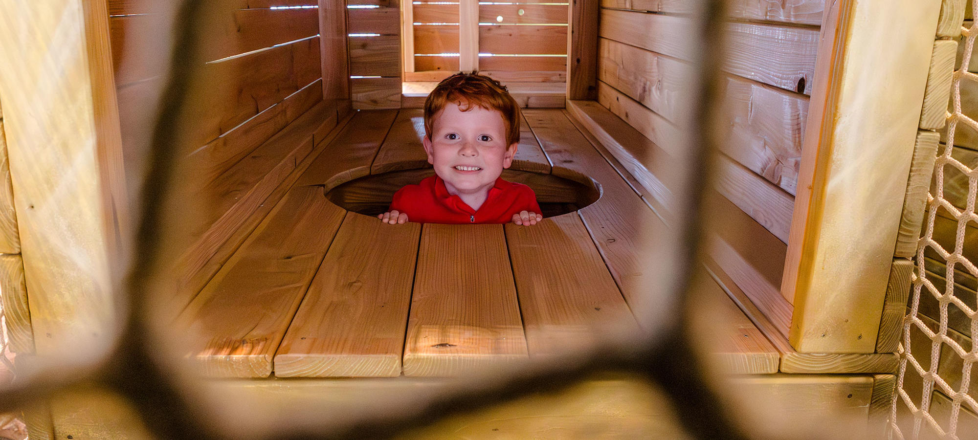 Young boy having fun in the Playbarn