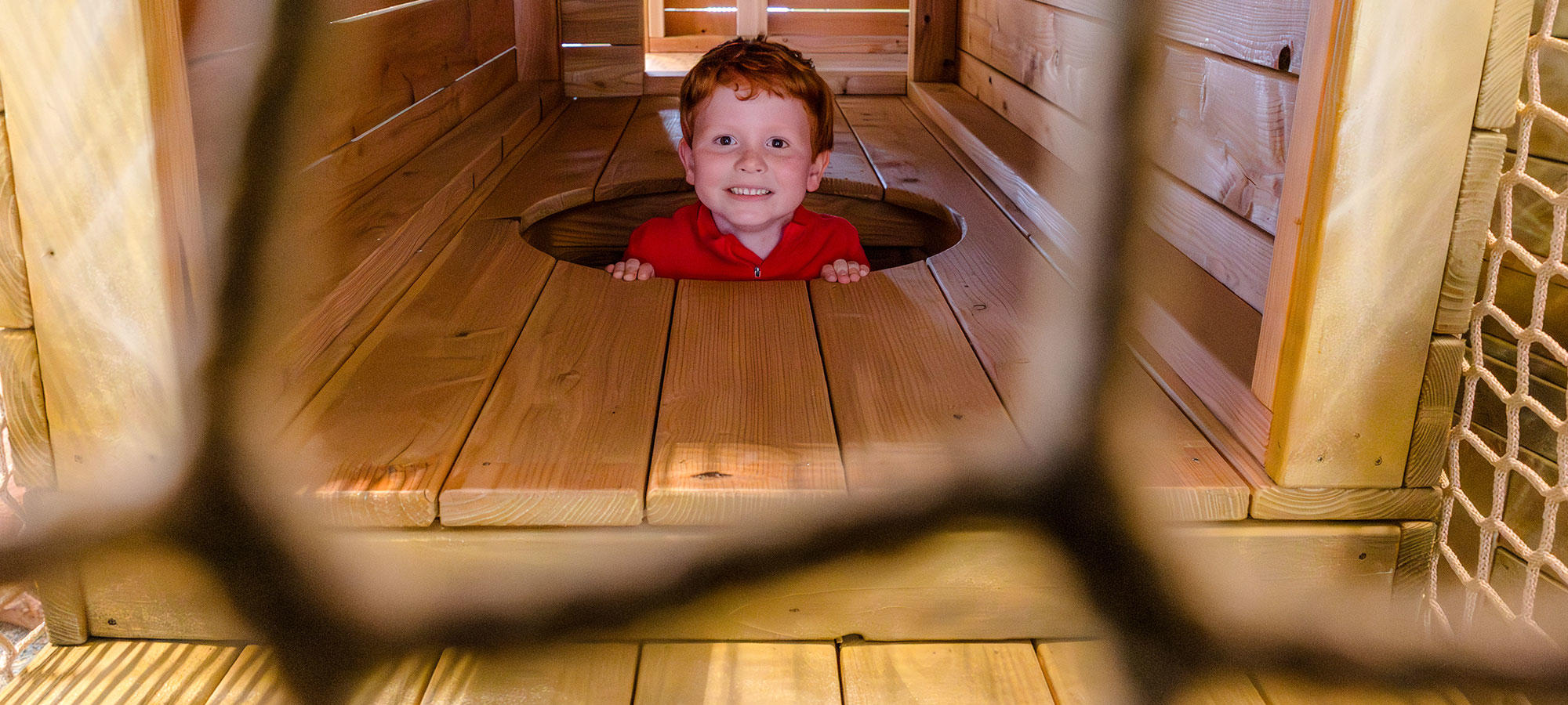 Young boy having fun in the Playbarn