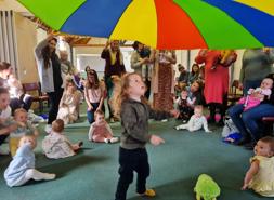 Children under a parachute at a Singalong with Liz session